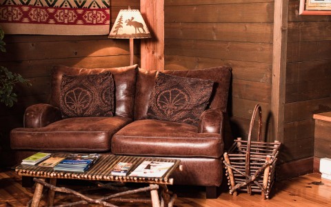 Small leather love seat in a cabin