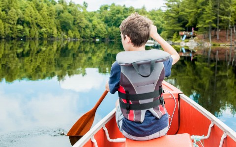 young boy kayaking 