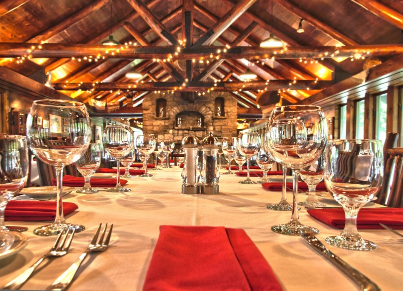 banquet hall in a log cabin style building decorated for fine dining dinner
