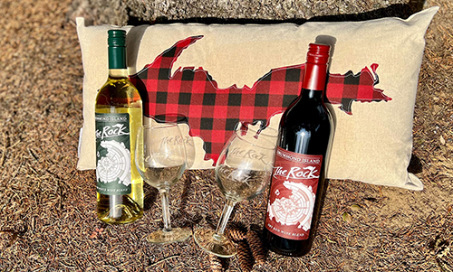 View of two bottles of wine on top of a pillow