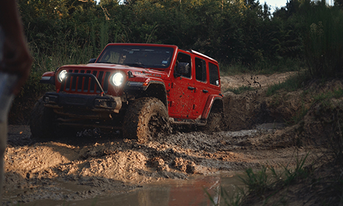 red jeep wrangler in the mud