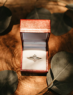 wedding ring in box displayed on a ring of wood
