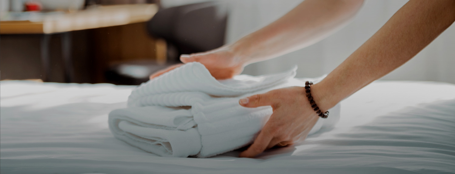 Hands of a woman holding a hotel towels 
