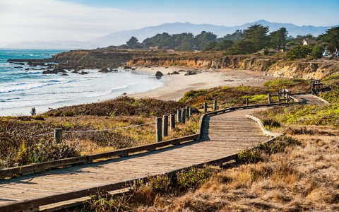 View of a big beach and a wooden road