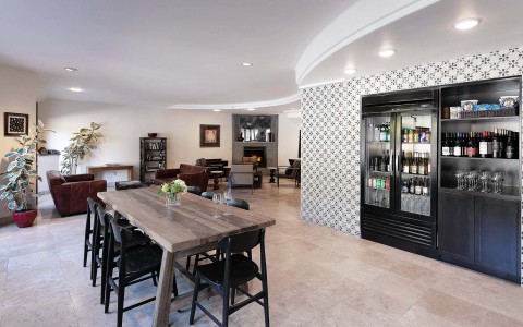 View of a large dining area and a big cabinet with wine bottles