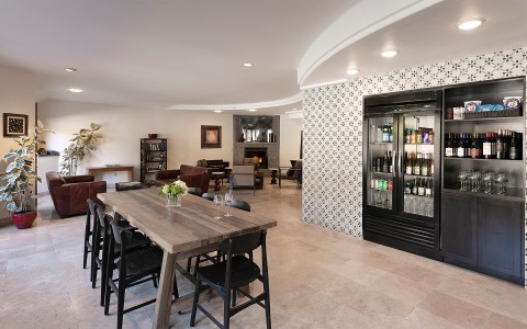 Lounge area with large fridge and wine bottles