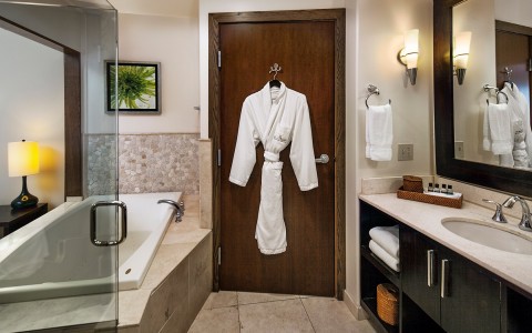a spa inspired bathroom with robes hanging
