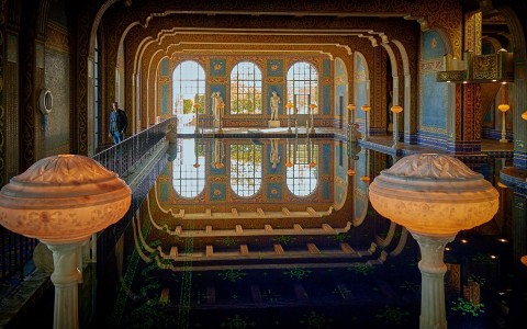 an indoor pool with roman statues