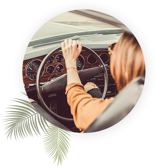 woman driving an old car