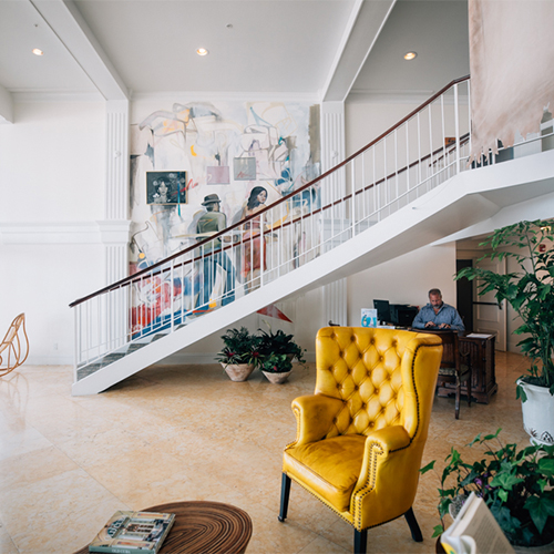 spacious entrance to havana cabana with an elegant stairwell