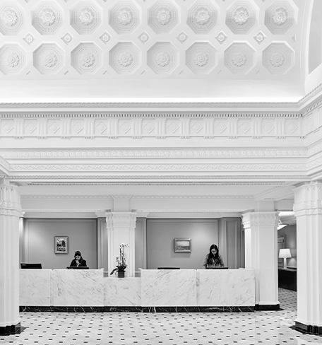 two women working behind a front desk in a lobby