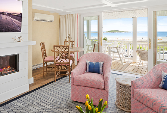 view of two pink chairs and a fireplace with a balcony in the background at the tides beach club