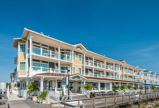 exterior view of bethany beach ocean suites on a sunny day