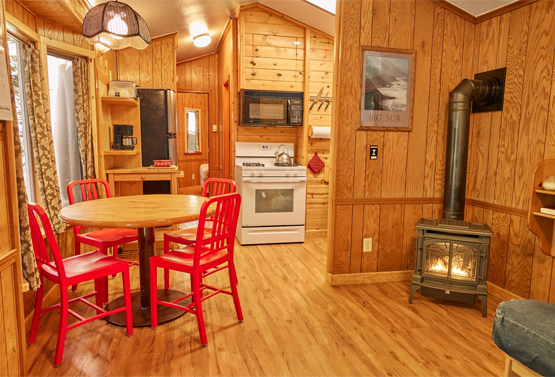 view of a cabin themed dining and kitchen area