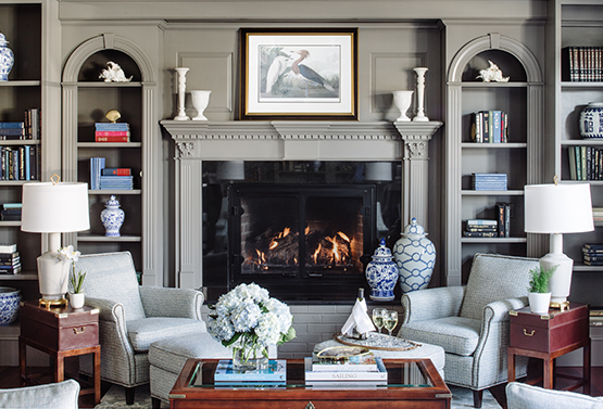 a lounge area with a fireplace and several bookshelves at the bellmoor