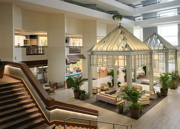 view of an elegant lobby with several plants and seating