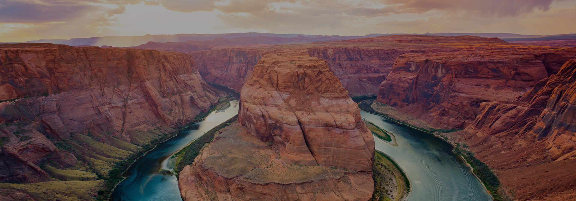 a drone shot of the rocky canyon at sunset