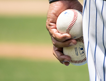 player holding two baseball in his hand