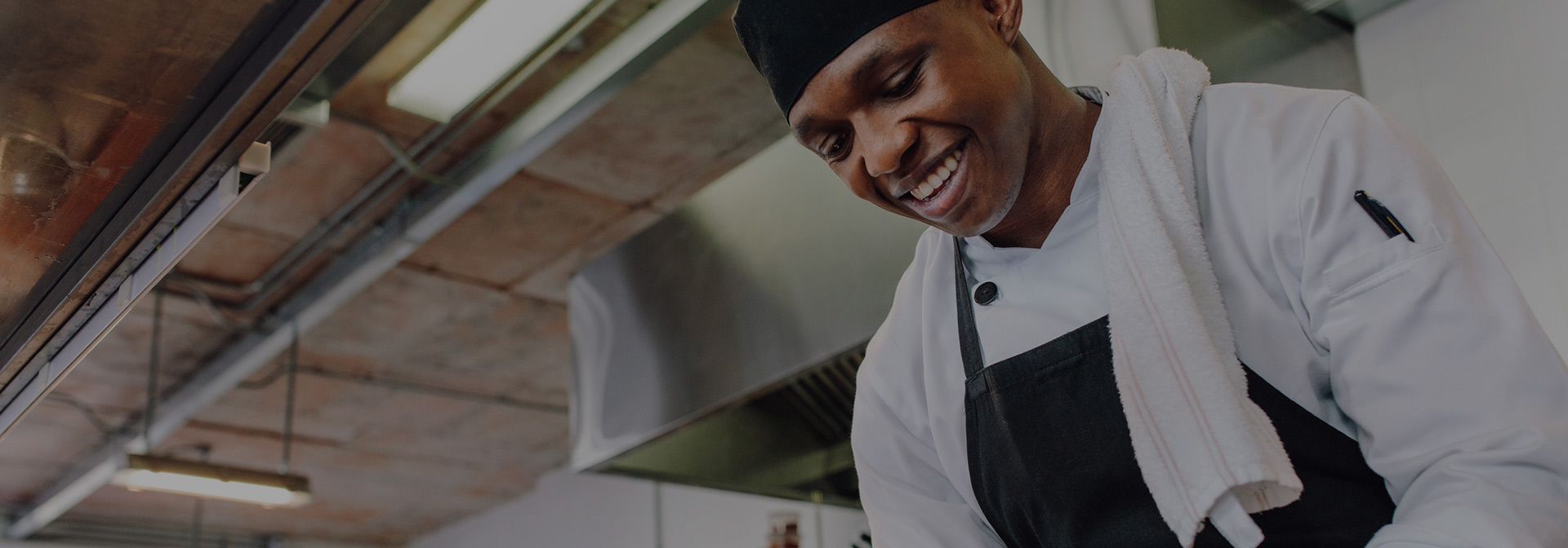 a smiling chef looking down