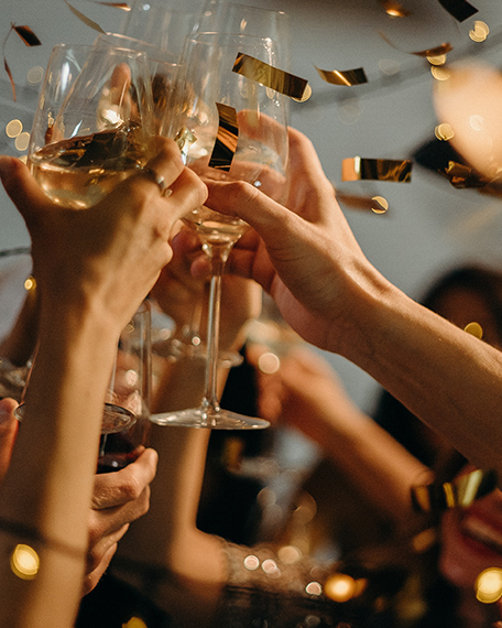 people clinking their champagne glasses together