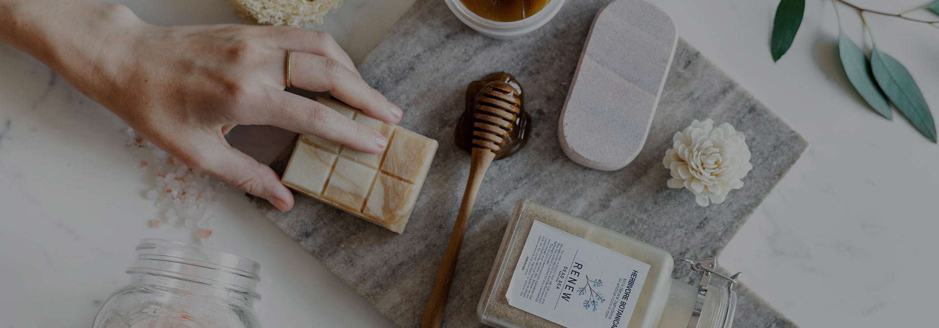 a person touching an artesian bar of soap