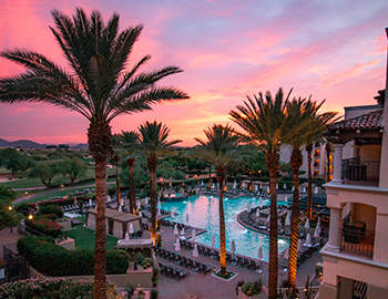 side view of the pool at sunset with dessert landscape in the background