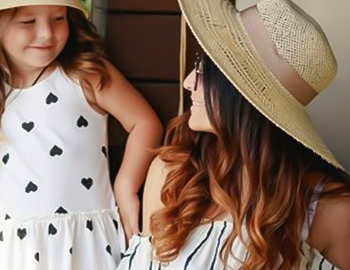 a smiling woman and little girl looking at each other
