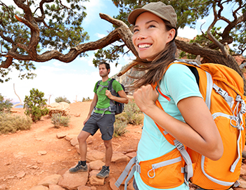a man and woman hiking during the day