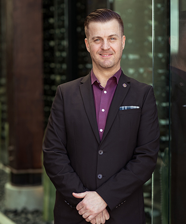 a smiling man wearing a business suit