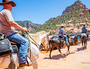 A group horseback riding in the desert Arizona