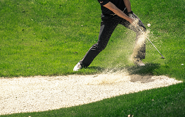 A man hitting the golf ball