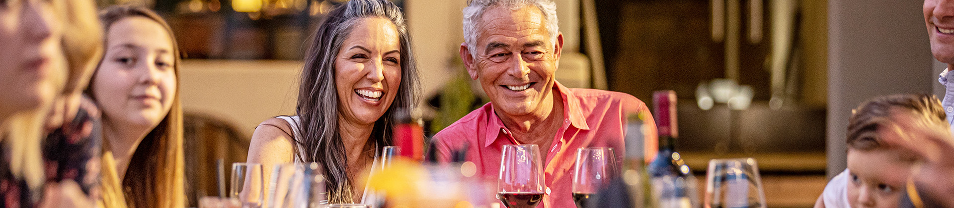 closeup of a smiling man and woman at a dinner table