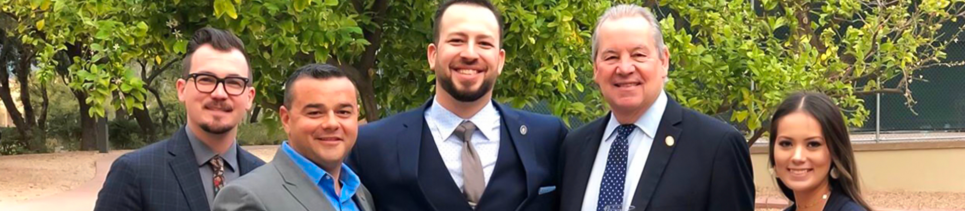 closeup of smiling man in a navy suit
