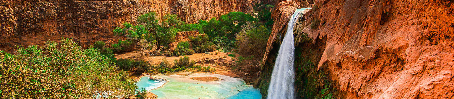 blue lagoon at the bottom of a dessert canyon