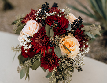 arrangement of yellow, white and red roses