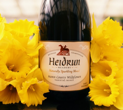 wine bottle next to yellow flowers-1