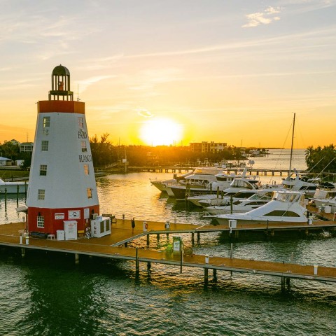 faro blanco lighthouse and marina at sunset