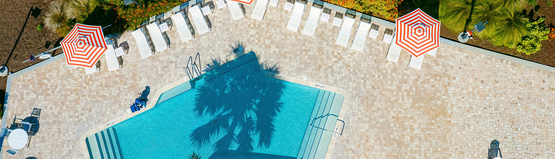aerial shot of hotel pool and white chairs