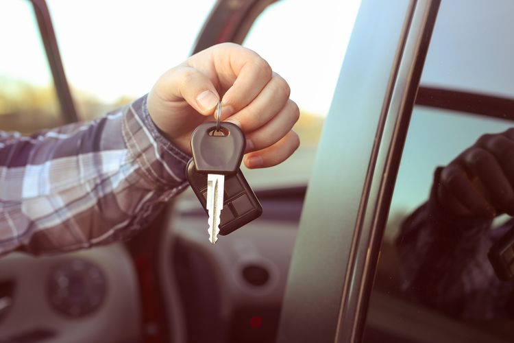 key in hand of car