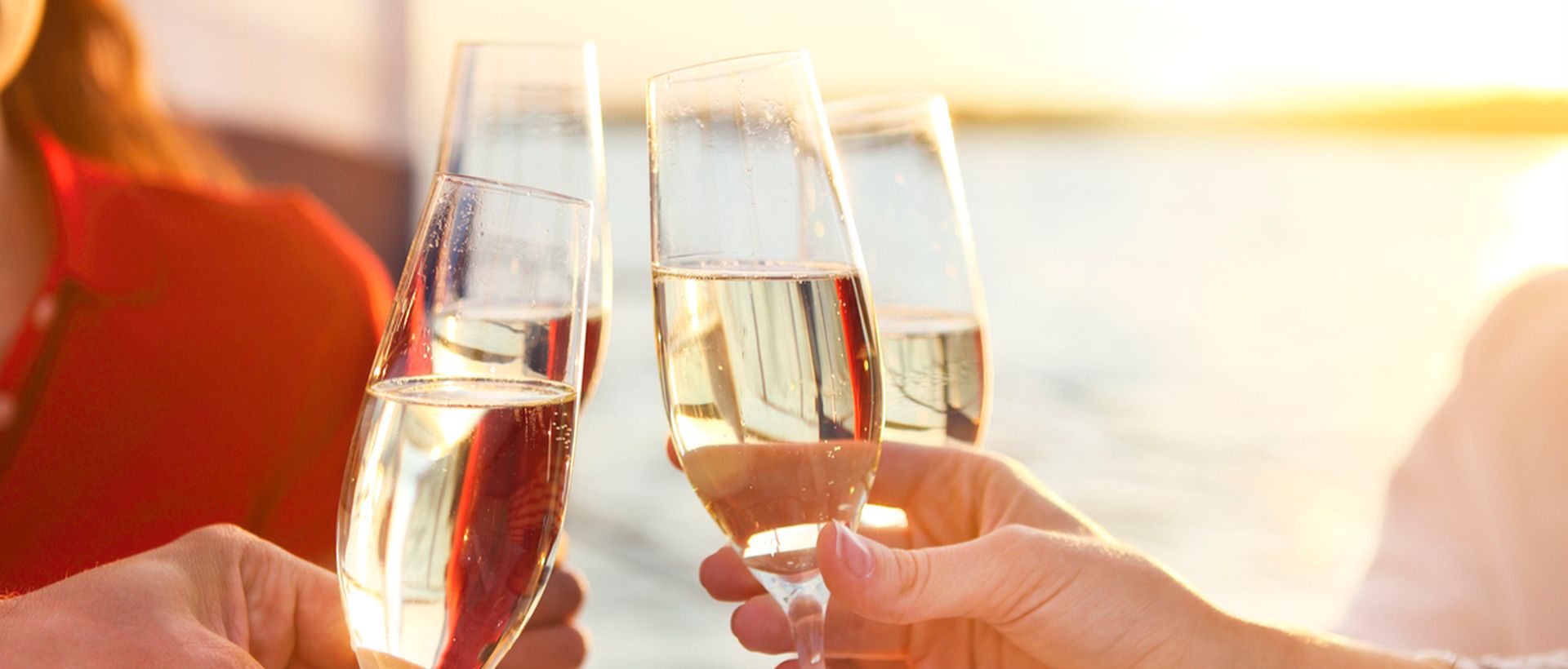 friends toasting by the water