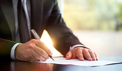 man writing something on paper