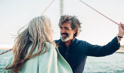 view of a couple laughing on a sailboat