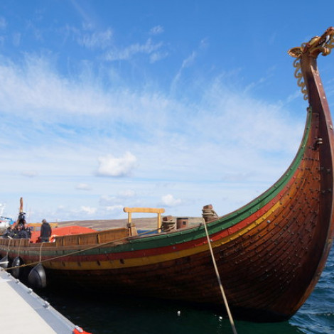 Viking Ship with Dragon Head docked on a modern dock