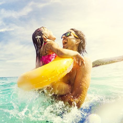 Father and daughter playing in the water