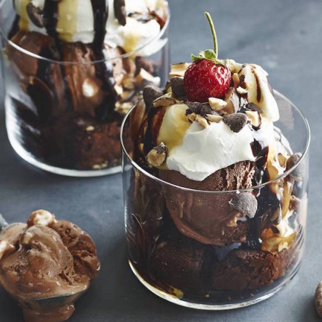 delicious chocolate sundaes toped with all the fixings in a glass cup
