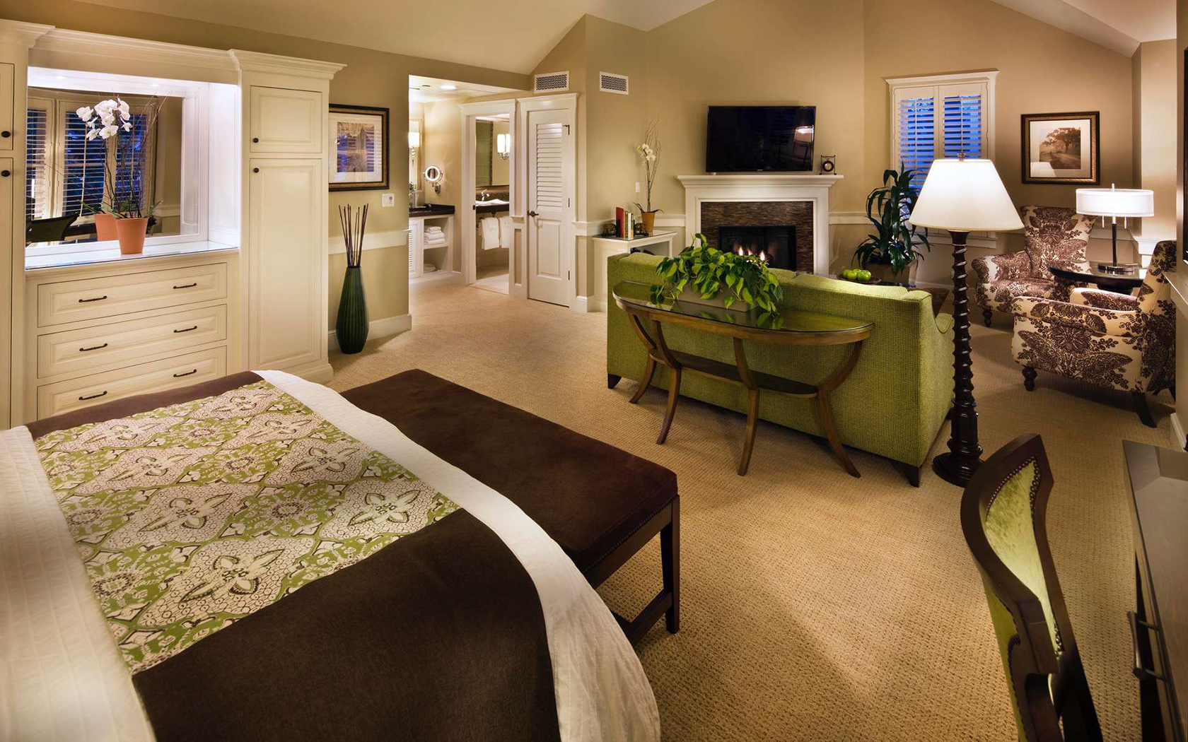 gallery a bedroom that features a bed with white bedsheets and a green and brown patterned throw