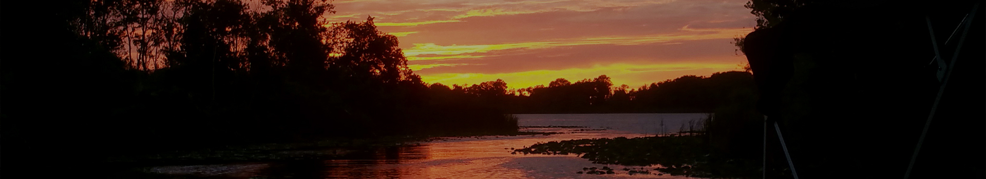 sin setting by the lake