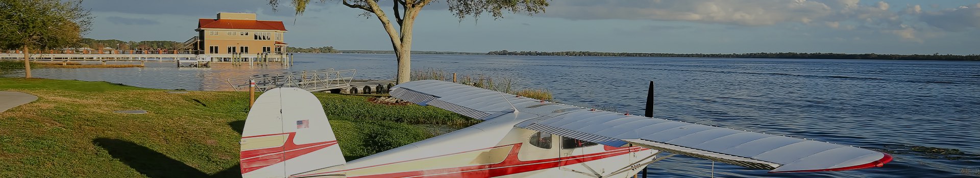 small hangar plane parked by the water