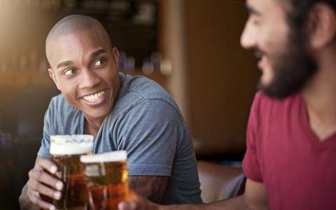 two guys having a beer at the bar