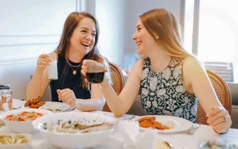 2 women enjoying a meal 